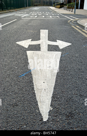 british road marking indicating traffic may turn left, right or go straight ahead Stock Photo