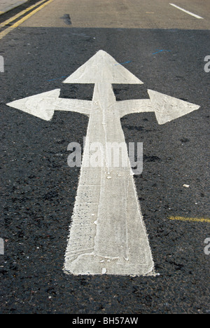 british road marking indicating traffic may turn left, right or go straight ahead Stock Photo