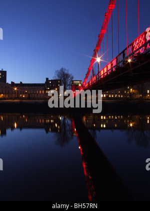 South Portland Street Red Suspension Bridge over the River Clyde, at sunrise, Glasgow Stock Photo