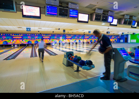 Bowling alleys with people playing bowling in a Bowling Center near Leipzig, Germany Stock Photo