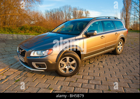 Front and side view of Volvo XC 70 four wheel drive station wagon in sunset parked in front of trees Stock Photo