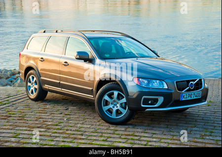 Front and side view of Volvo XC 70 four wheel drive station waggon in sunset parked in front of Rhine river Stock Photo