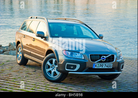 Front and side view of Volvo XC 70 four wheel drive station waggon in sunset parked in front of Rhine river Stock Photo