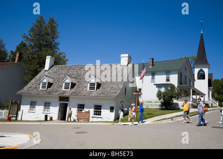 American Fur Company's retail store, Market and Fort Street, with Trinity Episcopal church, Mackinac Island, Michigan, USA Stock Photo