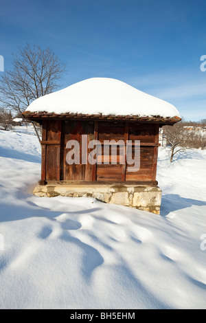 Village Lelic, traditional Serbian economic building 'vajat', house, architecture in West Serbia, winter, snow Stock Photo