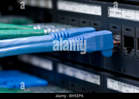 Fiber cables connected to servers in a datacenter Stock Photo