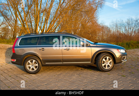 Side view of Volvo XC 70 four wheel drive station wagon parked in front of trees Stock Photo