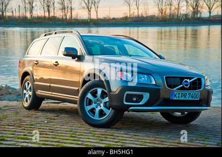 Front and side view of Volvo XC 70 four wheel drive station wagon in sunset parked in front of Rhine river Stock Photo