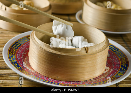 Dim Sum or Chinese dumpling in a stream hot pot of food wheelbarrow on  street food of Bangkok. Many dumpling in a wooden basket is streaming in  old As Stock Photo 