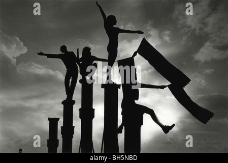 Contemporary dance troupe performing on the stanchions of the West Pier on Brighton Beach as part of the Brighton Festival. Stock Photo