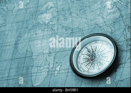 Compass on old map. Blue tone background Stock Photo