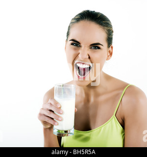 beautiful brunette caucasian woman on white background holding a glass of milk Stock Photo