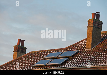 Solar panels fitted to the roof of a house in the UK. Stock Photo