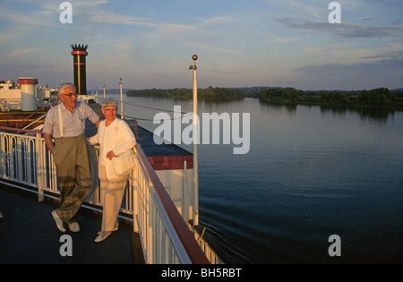 A senior citizen couple enjoys a lovely evening on the Tennessee River aboard the Mississippi Queen paddlewheel steamboat Stock Photo