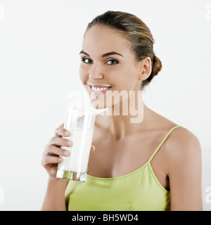 beautiful brunette caucasian woman on white background holding a glass of milk Stock Photo