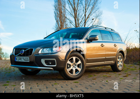 Front and side view of Volvo XC 70 four wheel drive station wagon in sunset parked in front of trees Stock Photo