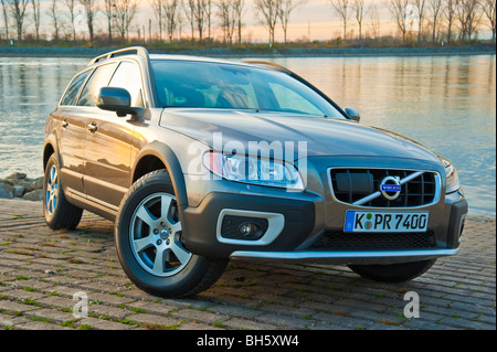 Front and side view of Volvo XC 70 four wheel drive station wagon in sunset parked in front of Rhine river Stock Photo