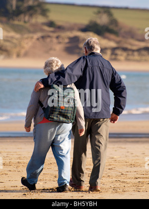 senior couple walking together on the beach, Padstow, Cornwall Stock Photo