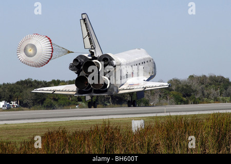 The Space Shuttle orbiter Atlantis, with its drag chute deployed, rolls ...