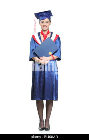 Student with a graduation gown posing, isolated on white background Stock Photo