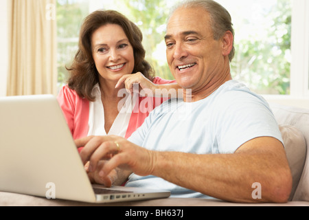 Senior Couple Using Laptop At Home Stock Photo