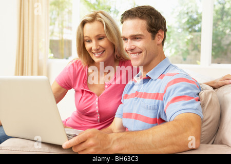 Young Couple Using Laptop At Home Stock Photo