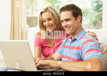 Young Couple Using Laptop At Home Stock Photo
