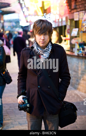 A young man with a camera Stock Photo