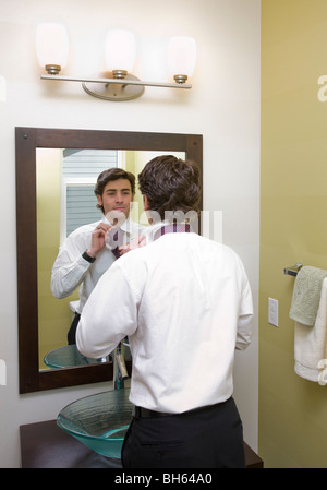 man getting dressed in mirror Stock Photo