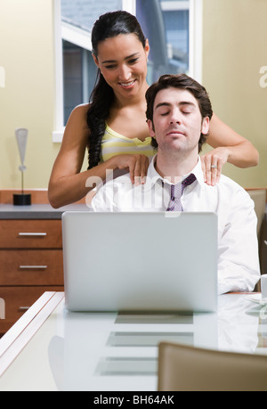 woman helping man relax at computer Stock Photo