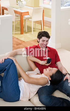 couple on couch taking photos Stock Photo