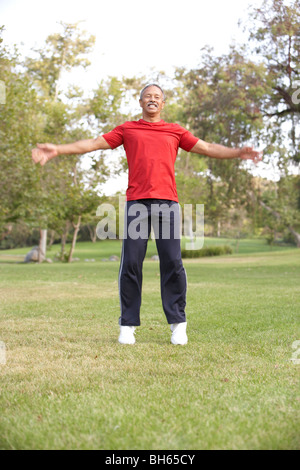 Senior Man Exercising In Park Stock Photo