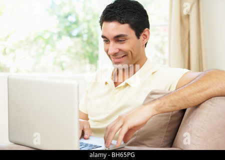 Man Using Laptop At Home Stock Photo