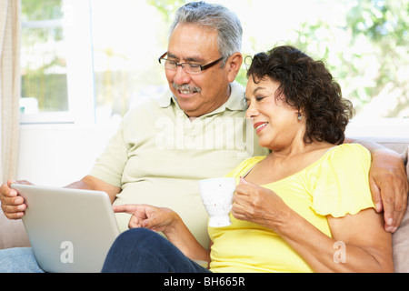 Senior Couple Using Laptop At Home Stock Photo