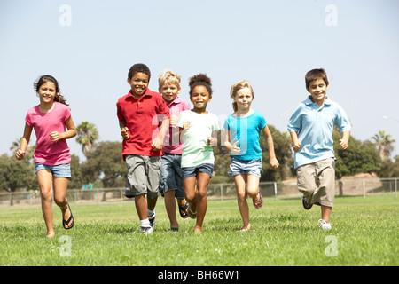 Group Of Children Running In Park Stock Photo