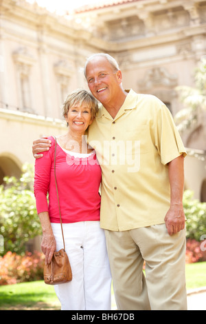 Senior Couple Walking Through City Street Stock Photo