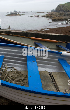 Detail of blue and white rowing boat on a Cornish beach in winter Stock Photo