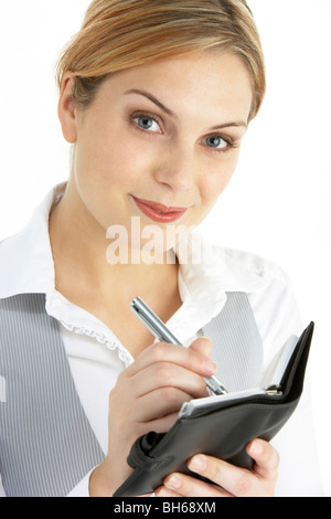 Blonde Businesswoman Writing In Diary Stock Photo