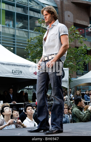 A male model poses on an outdoor cat walk show during the Montreal Fashion Week Stock Photo