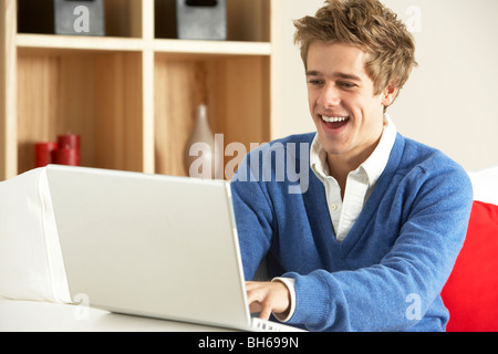 Man Using Laptop At Home Stock Photo