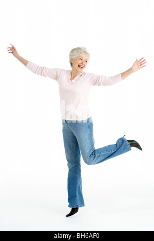 Full Length Studio Portrait Of Smiling Senior Woman Stock Photo