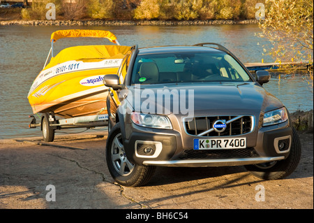 Volvo XC 70 towing a yellow ski power boat at Rhine river, Germany Stock Photo