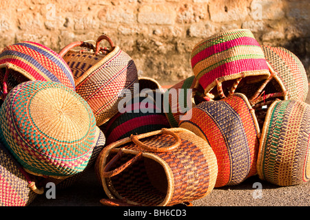 Several colourful tumbled baskets in the sunshine at Domme market, Perigord Noir, Dordogne, France. Stock Photo