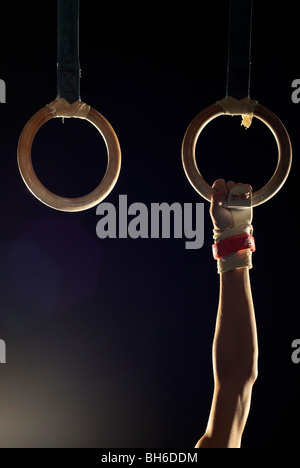 gymnast holding one ring Stock Photo