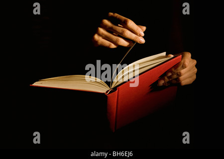 Hand turning the page Stock Photo