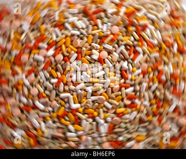 Abundance of medicines displayed on table as if looked through an addicts mind and hallucinating Stock Photo