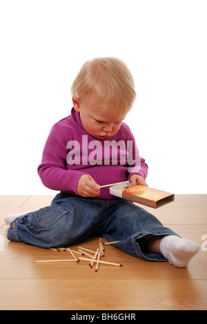 Young child playing with matches Stock Photo