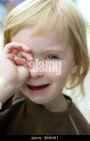 Adorable blond little girl crying closeup portrait Stock Photo