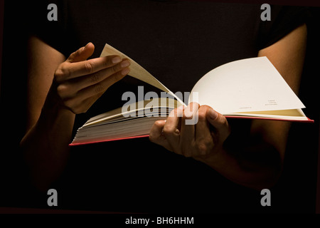 Hands holding book Stock Photo