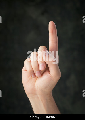 Hand pointing up with an index finger Stock Photo